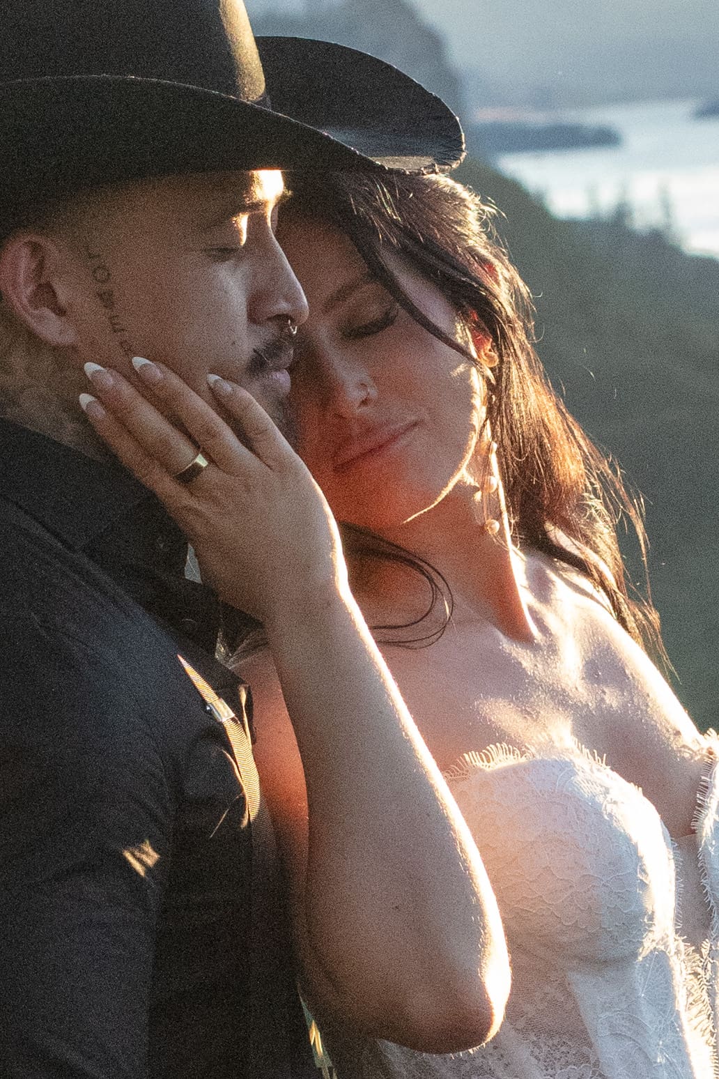 Intimate couple's portrait during a Griffin House wedding, with the Columbia Gorge glowing in the background.