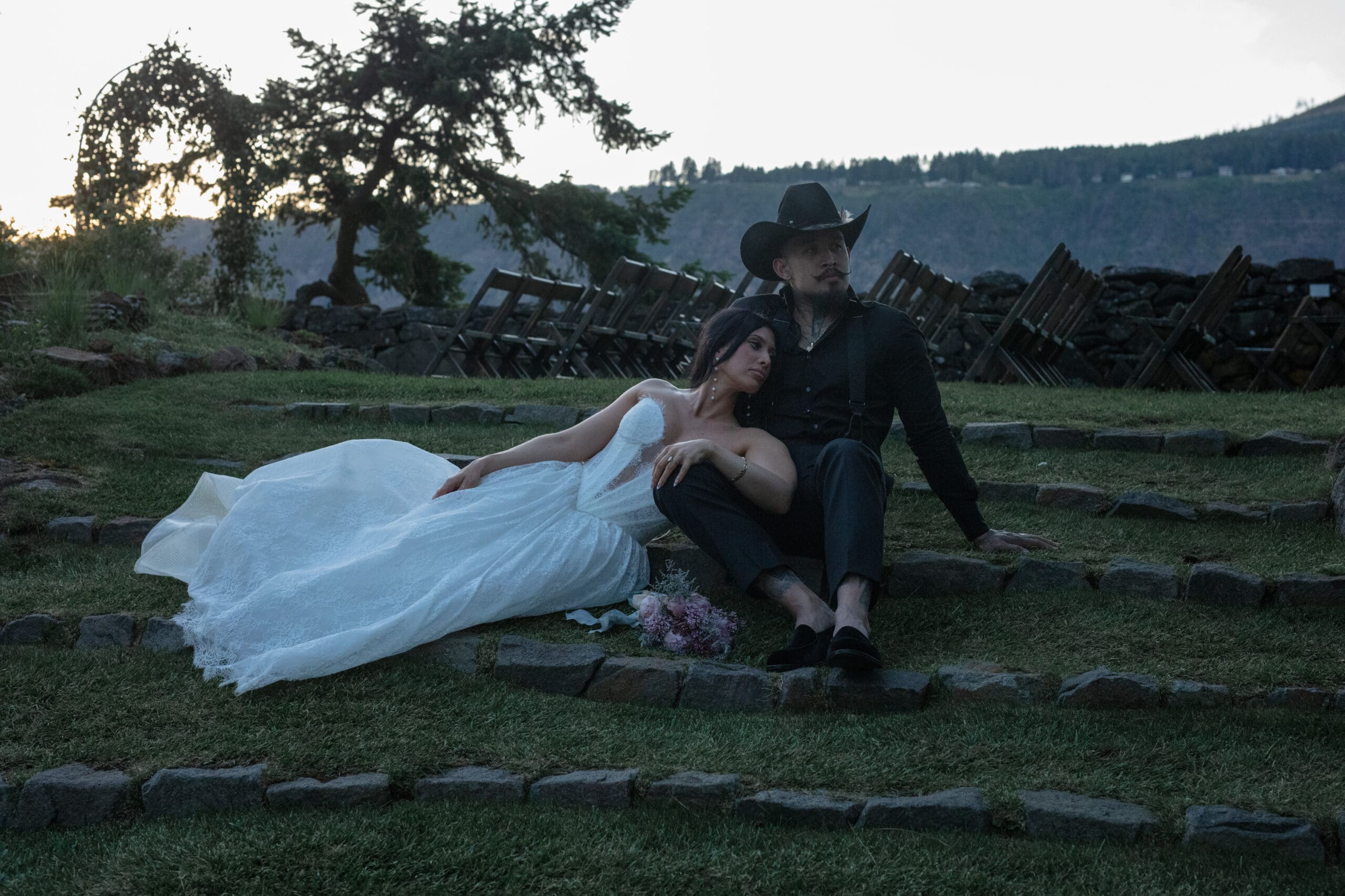 Bride and groom reclining on the stone amphitheater steps during a Griffin House wedding reception.