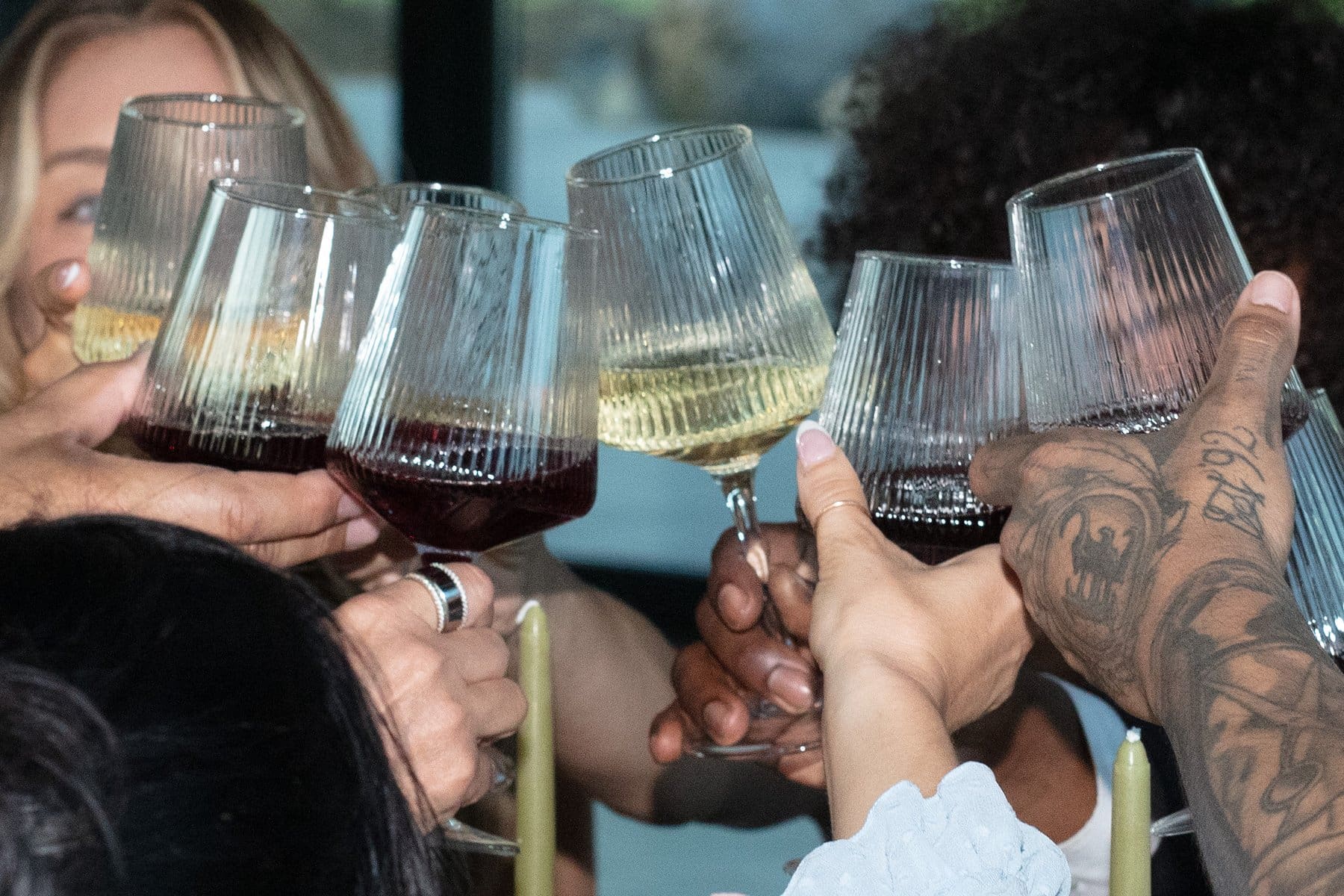 Wedding guests raise glasses of red and white wine for a toast during a celebration at Wind Mountain Ranch.