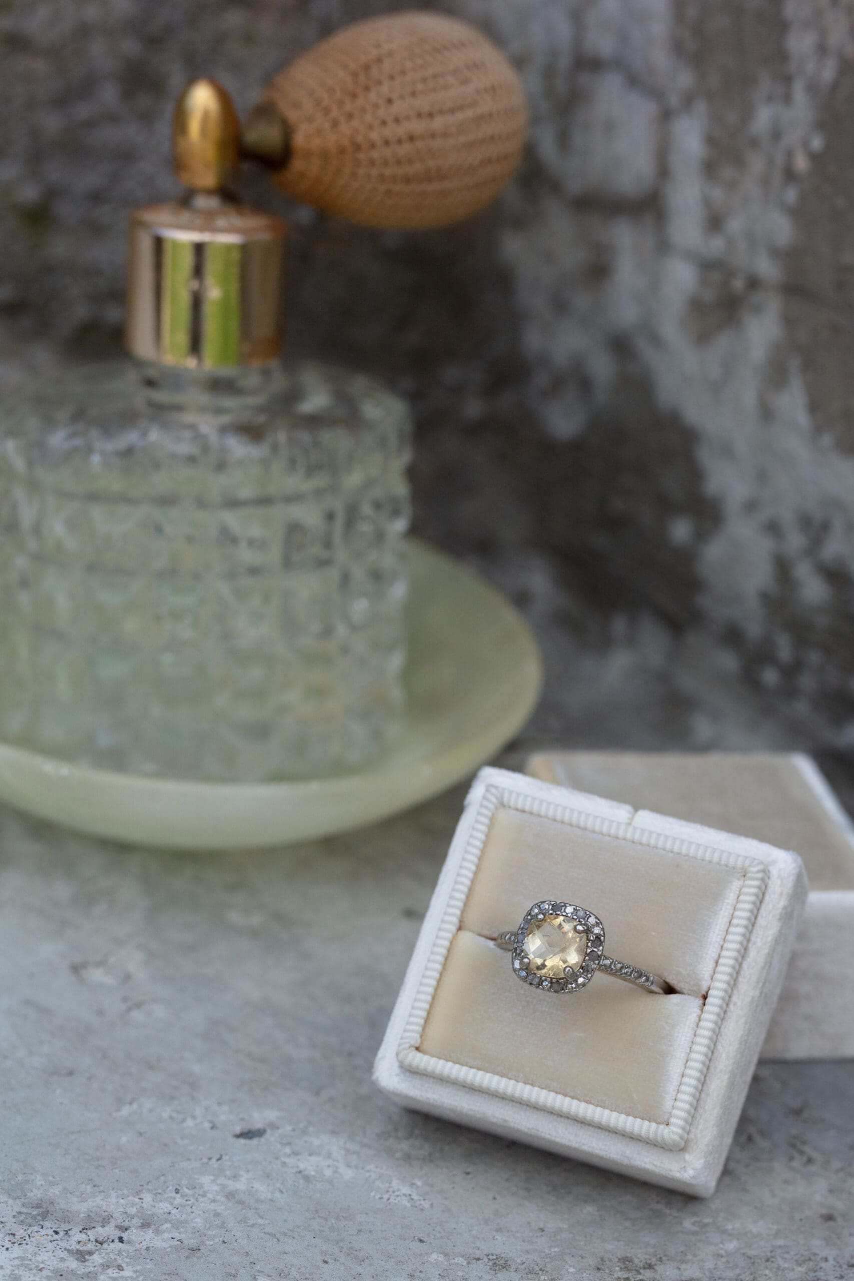 Vintage-style wedding details including a ring and perfume bottle—sentimental wedding ideas that tell a story.