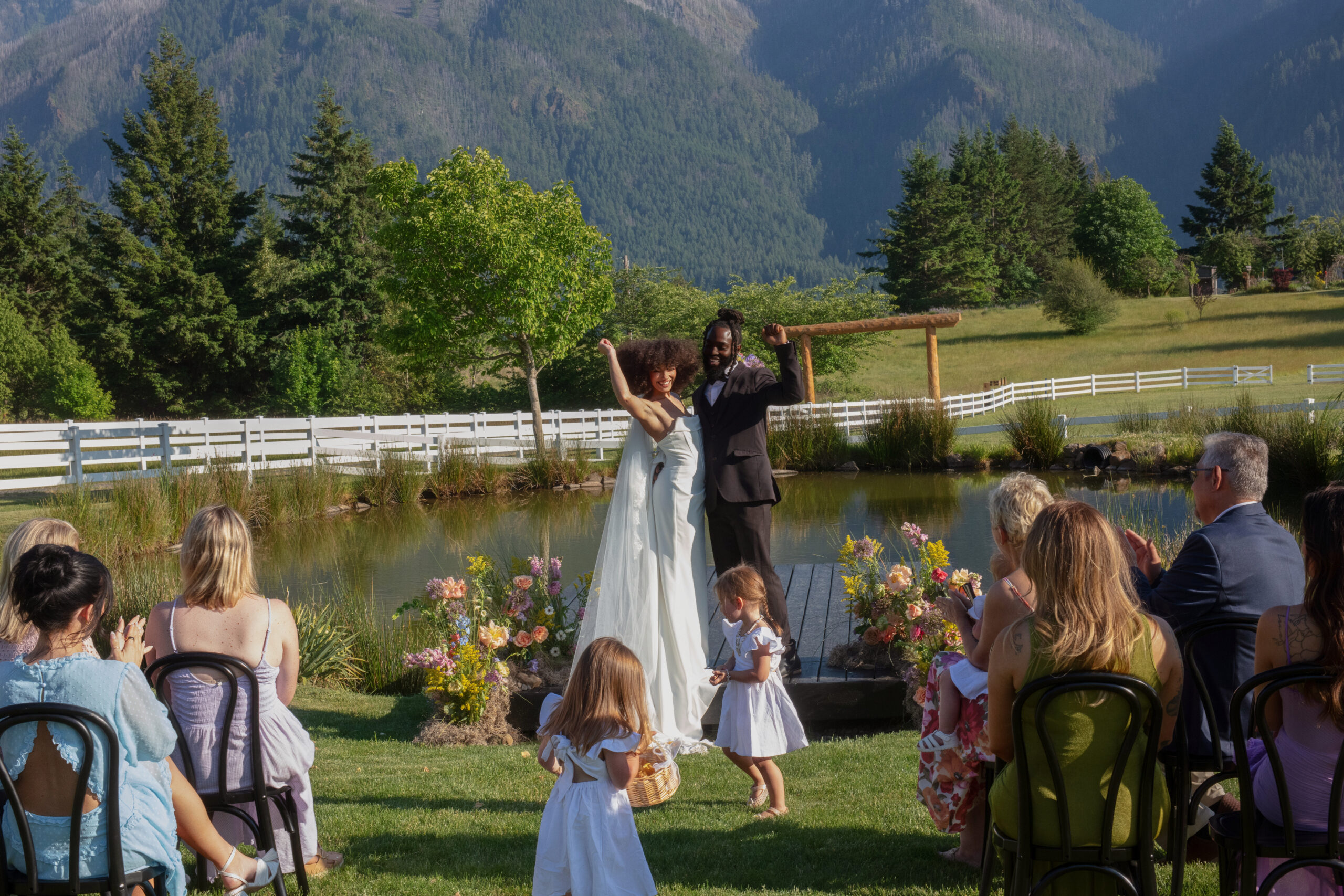 Couple celebrating their pondside wedding ceremony with guests in a scenic mountain setting—perfect inspiration for ideas for weddings in the Pacific Northwest.