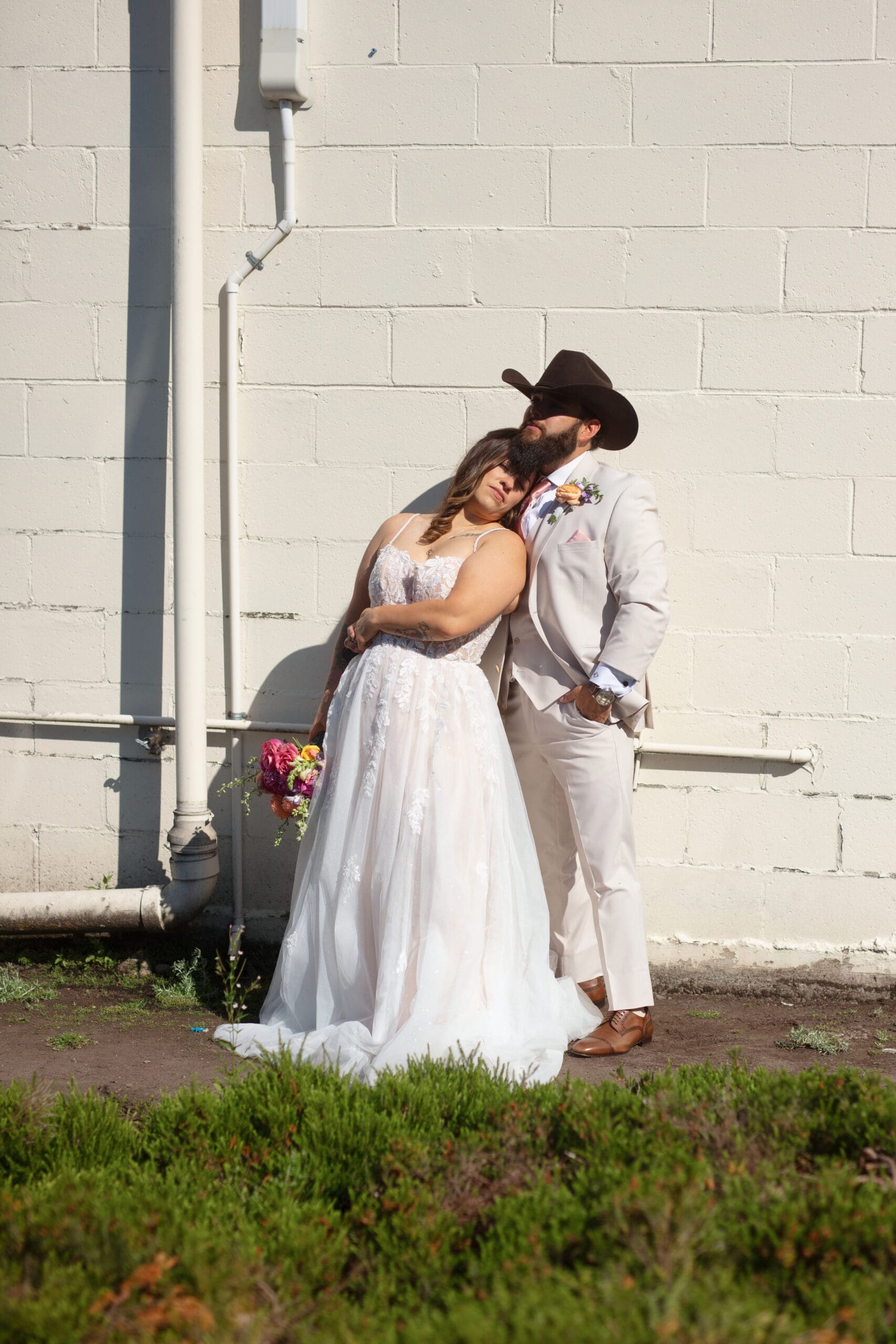 Bride and groom sharing a relaxed moment post-ceremony—showcasing modern yet heartfelt wedding vibes.