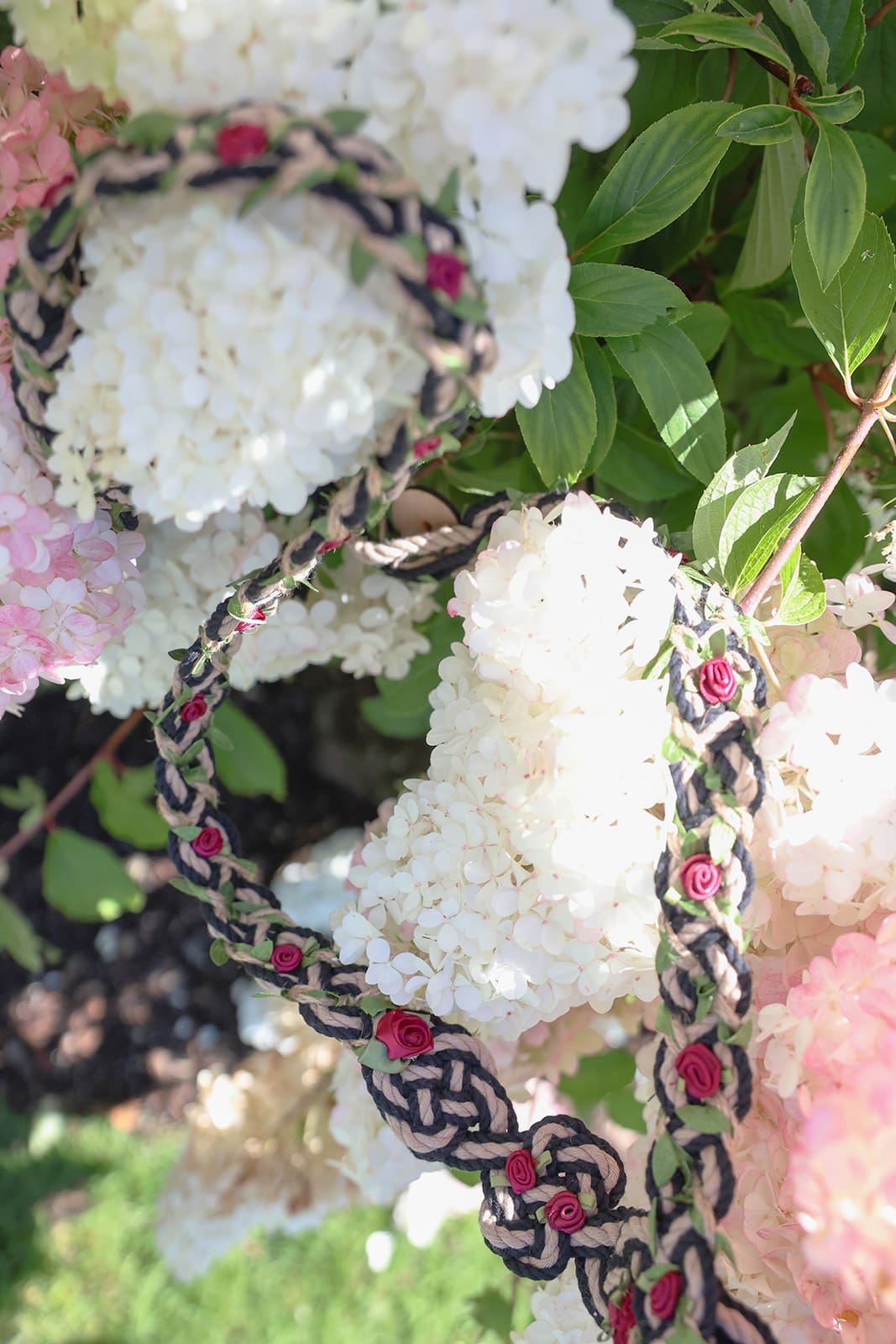 Close-up of the handfasting cord used in the ceremony, resting on soft white hydrangea blooms in the gardens of Cape Horn Estate.