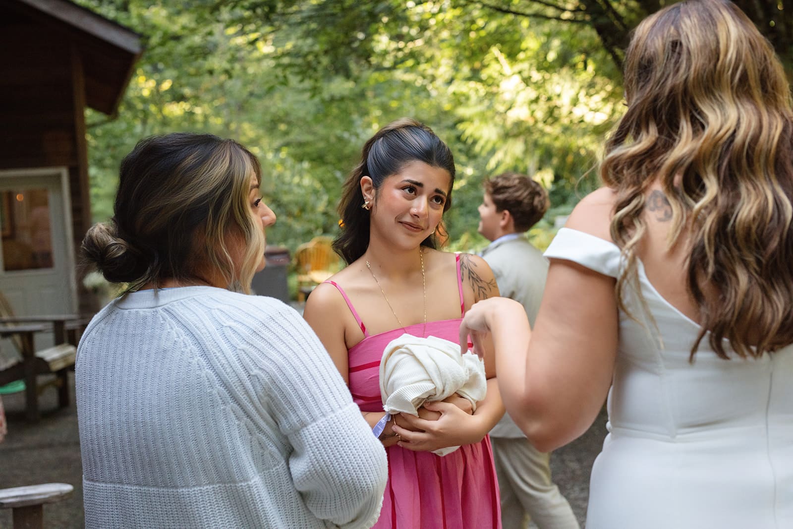The bride chats with guests outside the cabin, laughter and connection filling the air.