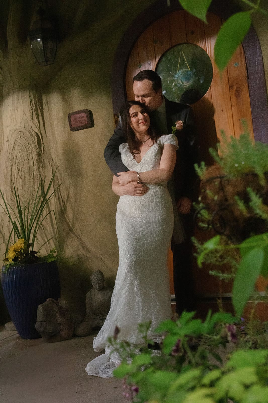 A cozy and intimate embrace outside a woodland cottage-style venue during a Washington elopement.