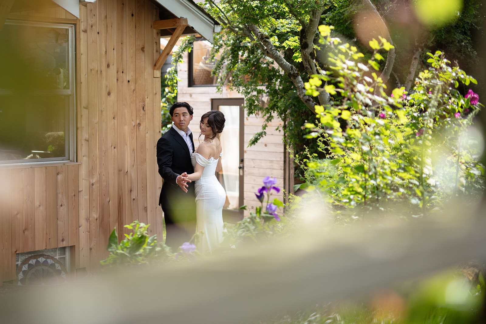 A quiet portrait tucked into a lush backyard garden, showing off the serene charm of a wedding in Washington state.