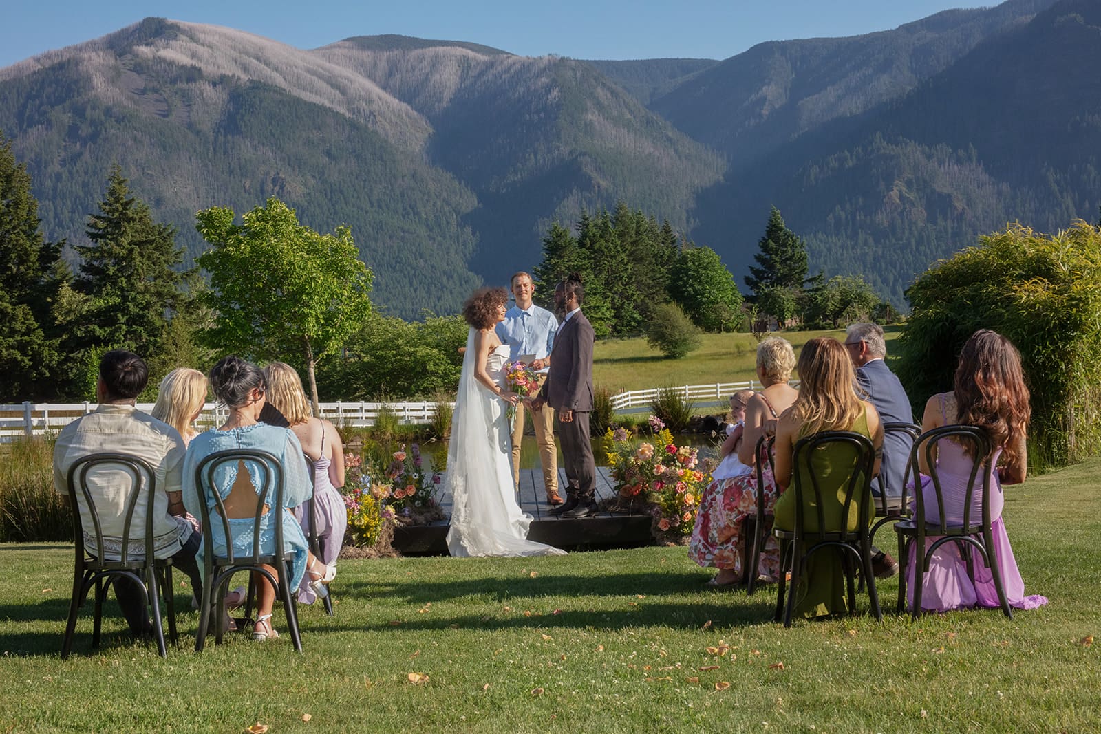 Outdoor ceremony with panoramic mountain views and loved ones gathered for a wedding in Washington state.